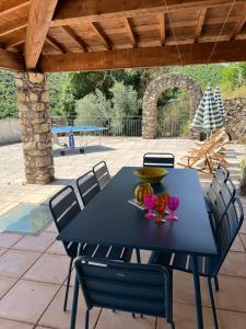 a blue table and chairs on a patio at Mas Daudé in Valleraugue