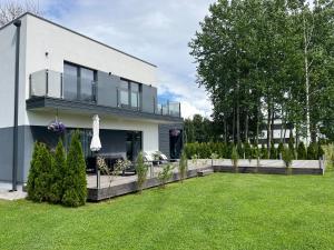 a house with a lawn in front of it at Kvissentali House in Tartu