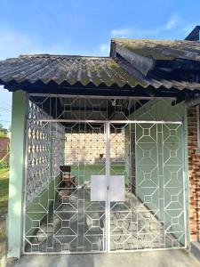 a metal pavilion with a white table in it at Ira's Abode in Dibrugarh