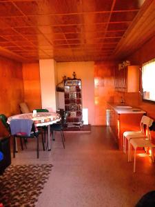 a living room with a table and a kitchen at Kemp pro karavan a stan s chatkou in Veselí nad Moravou