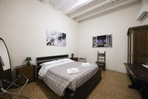 a bedroom with a bed and a desk and a piano at Nel Cuore di Bologna V ,Bologna by Shortholidays in Bologna
