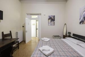 a bedroom with a bed with two towels on it at Nel Cuore di Bologna V ,Bologna by Shortholidays in Bologna +8 photos