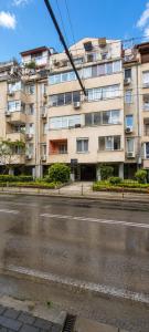 an empty street in front of a building at Comfortable Room in The City Centre in Varna City