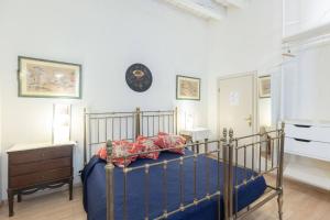 a bedroom with a bed and a clock on the wall at Nel Cuore di Bologna M ,Bologna by Shortholidays in Bologna