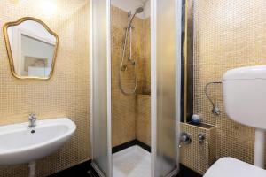 a bathroom with a sink and a toilet and a mirror at Nel Cuore di Bologna M ,Bologna by Shortholidays in Bologna