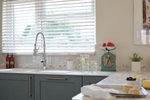 a kitchen counter with a sink and a window at Meadow Drive in Bembridge