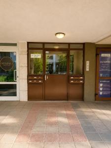 an office building with brown doors and windows at Comfortable Room in The City Centre in Varna City +7 photos