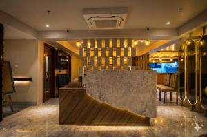 a lobby of a hotel with a counter and chairs at Hotel Everland Wish in Jaipur