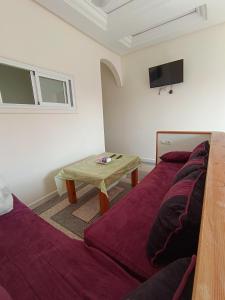 a living room with a couch and a table at Résidence Zaouit Aglou in Aglou