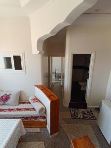 a bedroom with a bed and a stairway at Résidence Zaouit Aglou in Aglou