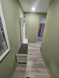 a empty hallway with a bench in a room at Taikos apartamentai in Utena