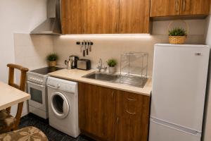 a small kitchen with a sink and a refrigerator at Comfortable Room in The City Centre in Varna City