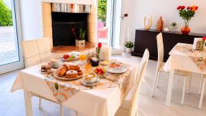a dining room with a table with food on it at Boat dreams , garden relax in Matino