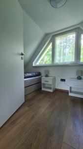 an attic room with a bed and a window at Officium P49 in Rakamaz