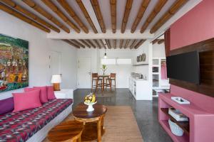 a living room with a couch and a table at PinkCoco Gili Trawangan - Constant Surprises - for Cool Adults Only in Gili Trawangan