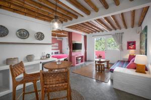 a living room with a couch and a table at PinkCoco Gili Trawangan - Constant Surprises - for Cool Adults Only in Gili Trawangan