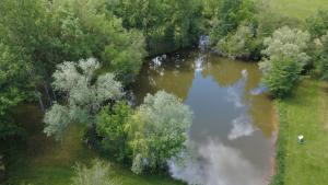 an aerial view of a river with a person in the water at Mondeslandhaus in Courrensan