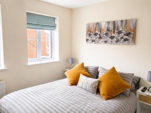 a bedroom with a bed with yellow pillows at Diamond View Stylish 3BR Ideal 4 Professionals in Chilton