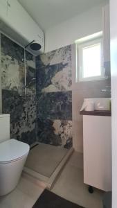 a bathroom with a toilet and a sink at Officium P49 in Rakamaz