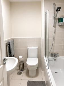 a white bathroom with a toilet and a sink at Diamond View Stylish 3BR Ideal 4 Professionals in Chilton +11 photos