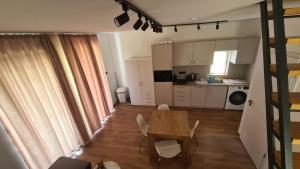 a kitchen and dining room with a table and chairs at Officium P49 in Rakamaz