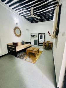 a living room with a couch and a table at NorArt House in Zanzibar City