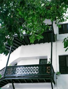 a black iron balcony on a white building at NorArt House in Zanzibar City