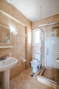 a bathroom with a toilet and a sink and a shower at Corfu Dream Holidays Villas Standarts in Glyfada +48 photos