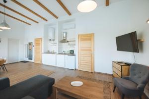 a living room with a couch and a tv at Olivér cölöpház in Tiszafüred +29 photos