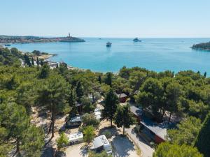 an aerial view of a beach with trees and water at Porton Nature Hideouts Pitches in Rovinj +43 photos