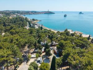 an aerial view of a beach with trees and water at Porton Nature Hideouts Pitches in Rovinj