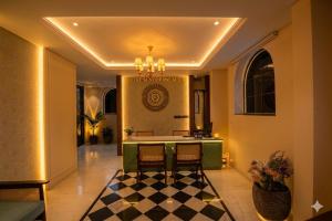 a lobby with a counter with chairs and a sign on the wall at The Sunder Palace-Jaipur City Centre Hotel in Jaipur