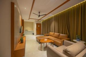 a living room with a couch and a table at Leal Resort-Wayanad in Meppādi
