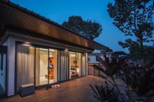 a house with glass doors and a patio at Leal Resort-Wayanad in Meppādi