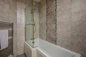 a bathroom with a shower and a bath tub at 5 Bed in Tynemouth oc-cn125 in Tynemouth +17 photos
