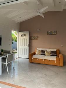 a living room with a couch and a table at Chez BIBI in Grand-Bourg