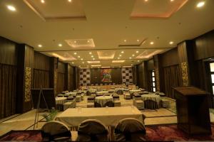 a large room with tables and chairs in it at Surya Garden in Tālcher
