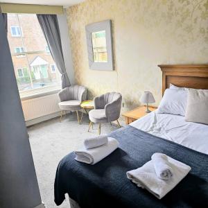 a bedroom with a bed with two towels on it at The Waggon & Horses in York +3 photos