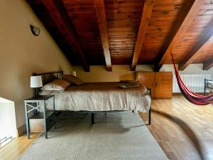 a bedroom with a bed and a wooden ceiling at La Casa deMercadillo in Liérganes +32 photos