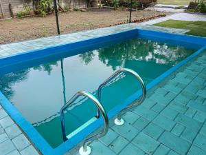 a lap pool with a swing in the water at White House KMCT in Kapūrwāhāl