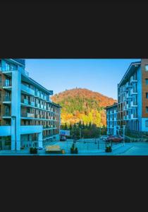 a view of a city with buildings and a mountain at Aparthotel Room 107 at Orbi Palace in Bakuriani in Bakuriani