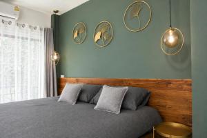 a bedroom with a bed with four mirrors on the wall at Villa Archie INCREDIBLE Sea View second fl in Ko Phangan
