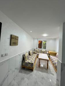a living room with couches and a table at Dar l Bihar in Al Hoceïma