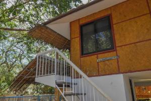 a staircase leading up to a house with a window at Ohana in Coron