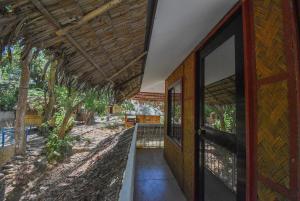 an entrance to a house with a wooden door at Ohana in Coron