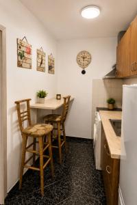 a kitchen with a small table and chairs in it at City Centre Room Near Everything in Varna City