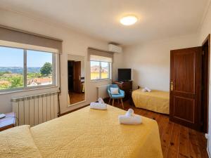 a hotel room with two beds and a window at Casa Machado in Vila Real +19 photos