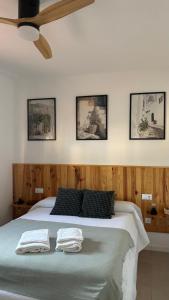 a bedroom with a bed with two towels on it at El Mirador del Asno in El Bosque