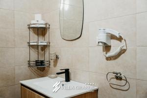 a bathroom with a sink and a mirror at Villa Grande Terrace Jacuzzi Suite in Bugojno +1 photo