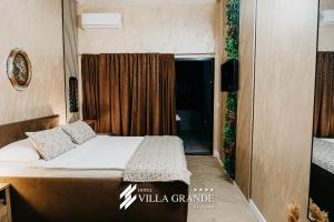 a small bedroom with a bed and a window at Villa Grande Terrace Jacuzzi Suite in Bugojno